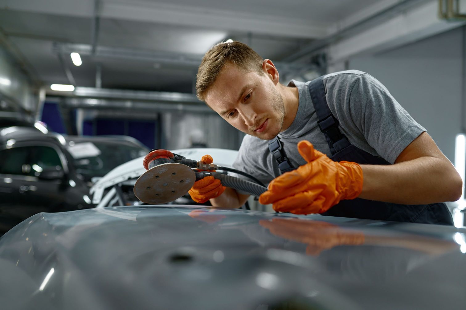 Young mecanician renovating an old car